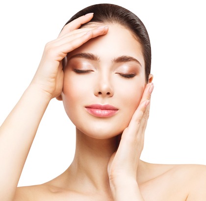 Beautiful woman with clean, clear skin feeling face, eyes closed